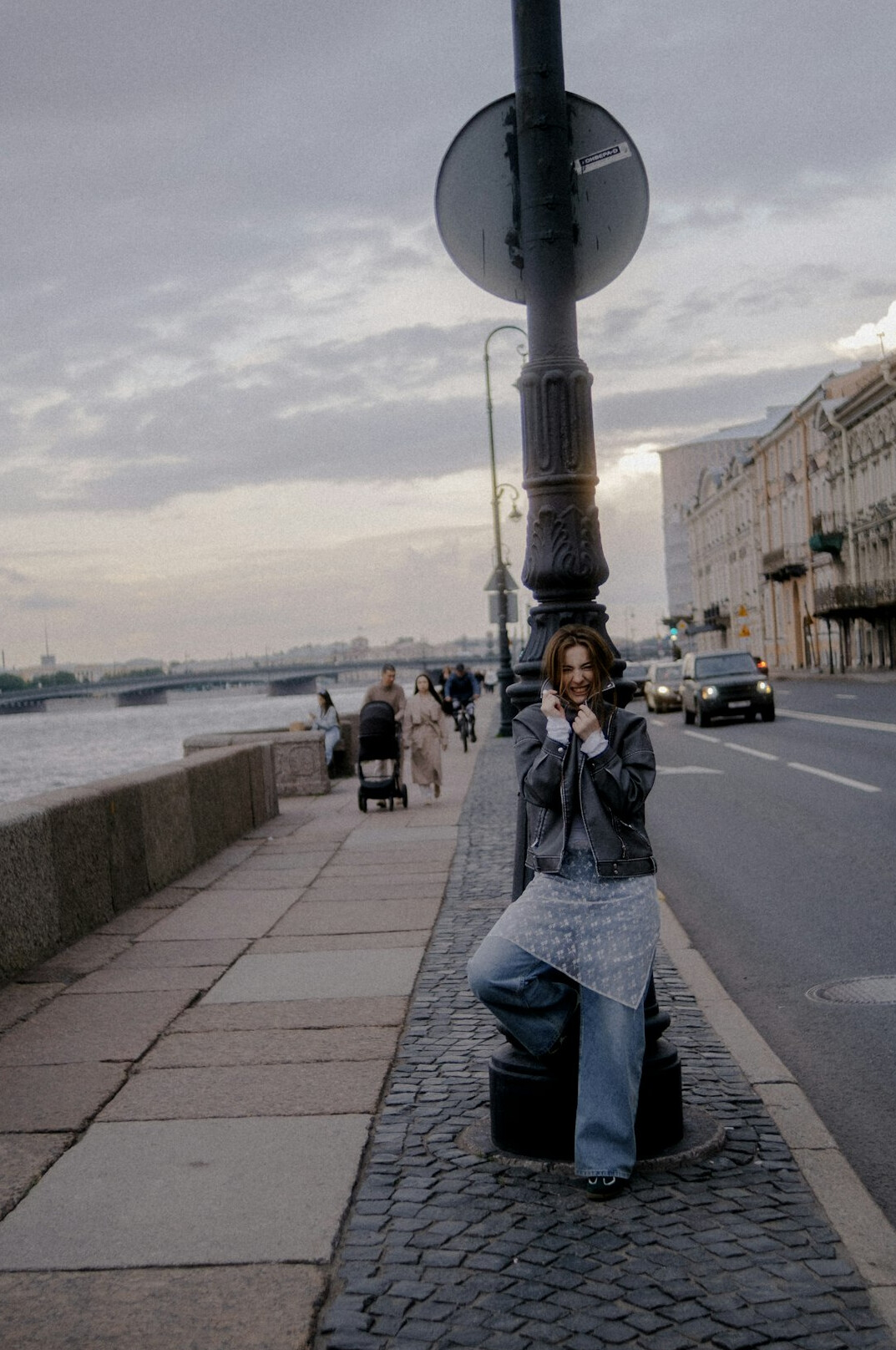 Photographer crouching to take a photo on a city sidewalk